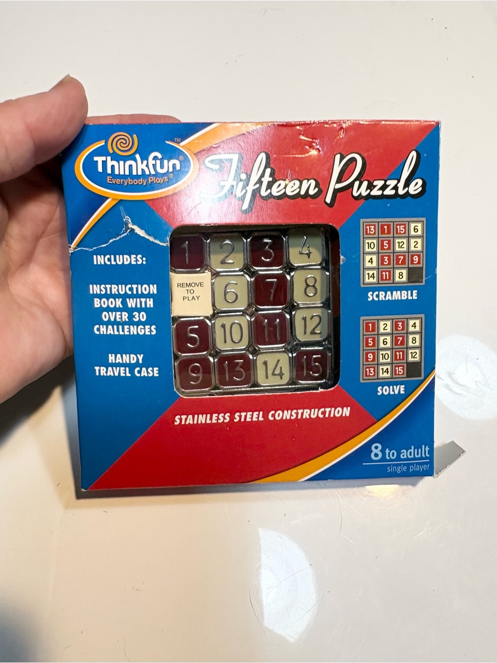 the ThinkFun Fifteen Puzzle, a classic metallic sliding-tile brain teaser